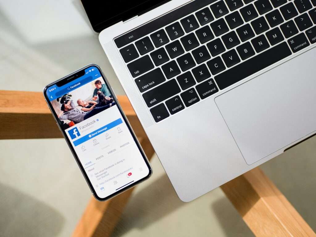 iPhone X beside MacBook on facebook thepointspage